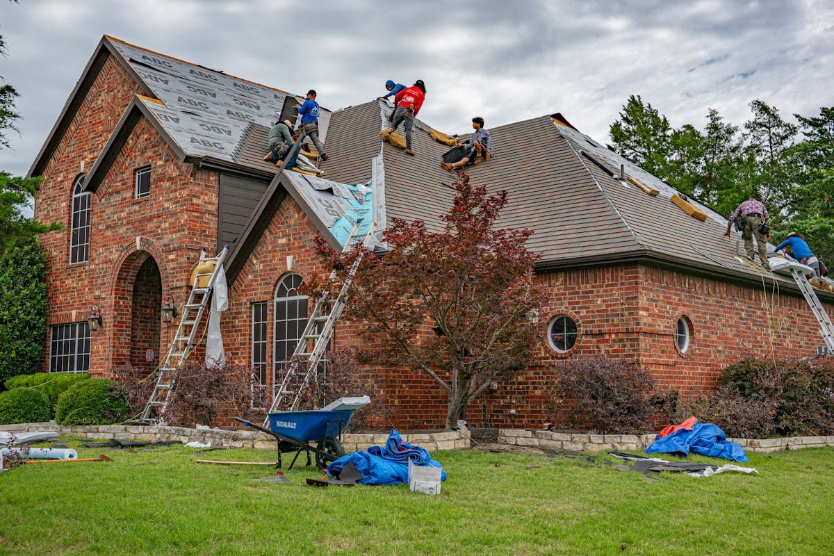 A roofing crew installing shingles on a residential home